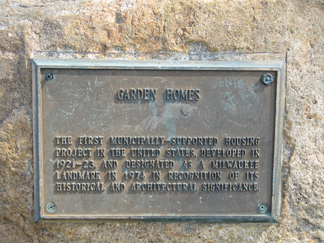 Garden Homes plaque Metal plaque with writing.