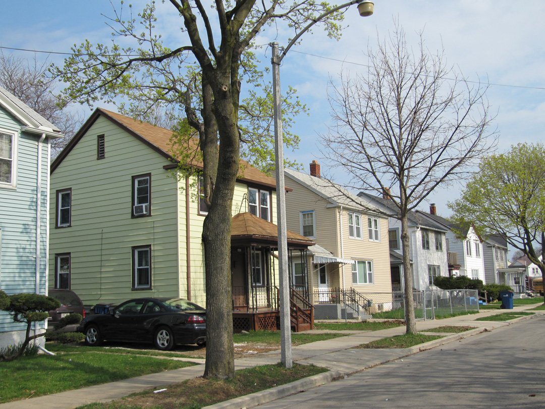 Garden Homes street Six houses in a row with a street in front.