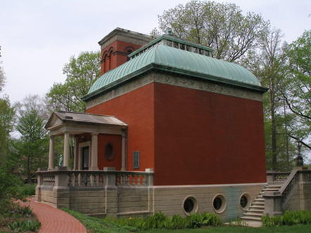 Red brick building with a green roof.