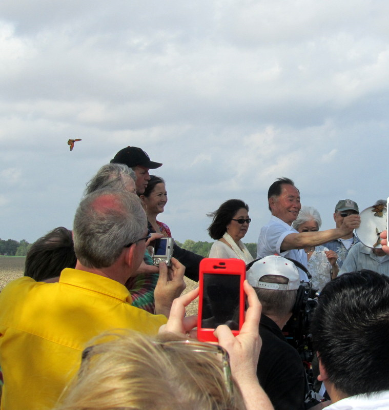 George Takei at the dedication ceremony. A group of people releasing butterflies.