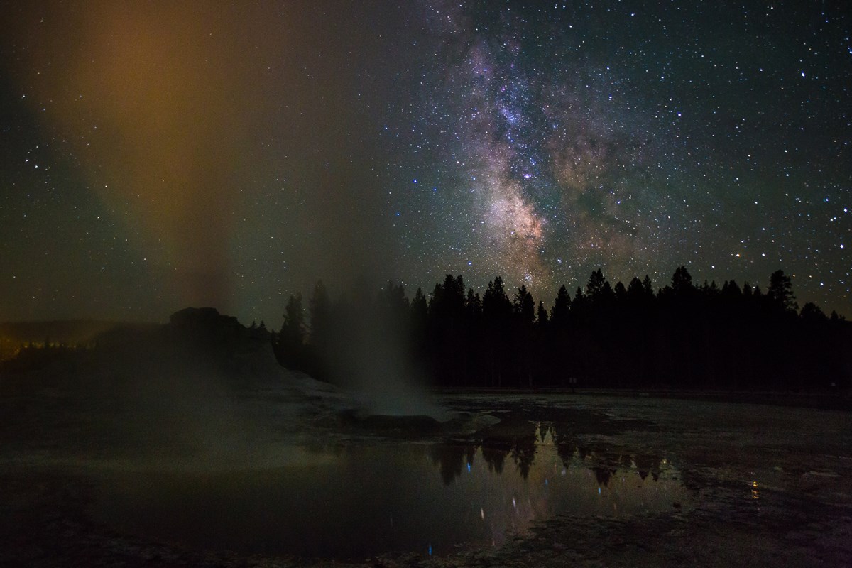Steaming geysers spray skyward to the starry night at Yellowstone National Park, Wyoming. Steaming geysers spray skyward to the starry night at Yellowstone National Park, Wyoming.