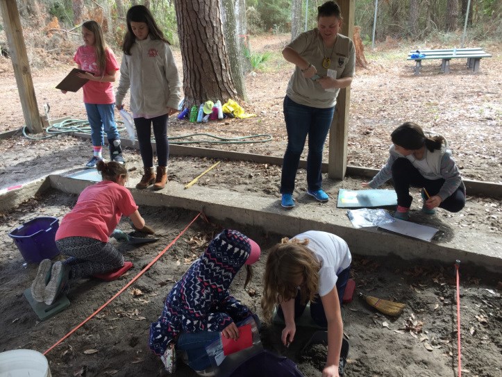 Girl scouts excavating in “Shiner’s Trench” at Fort Frederica National Monument Archeologist assisting Girl scouts excavate in “Shiner’s Trench” at Fort Frederica National Monument