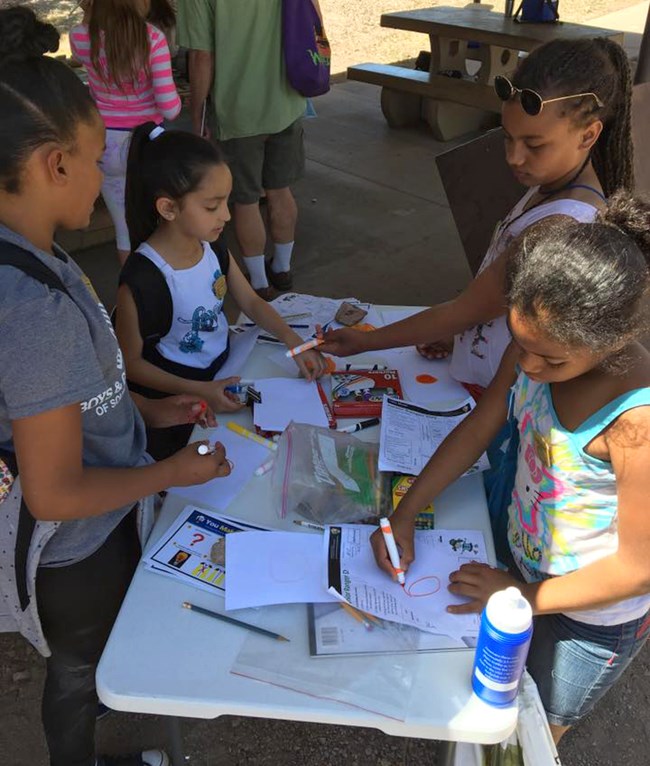 A group of girls works on a project raising awareness on light pollution