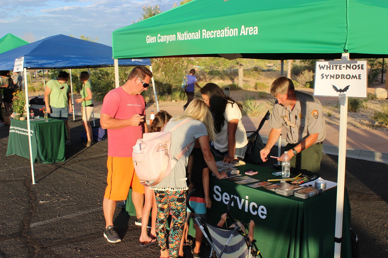 visitors at an educational fair booth