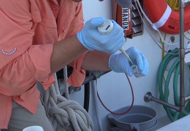 lt= water quality samples being taken on a boat