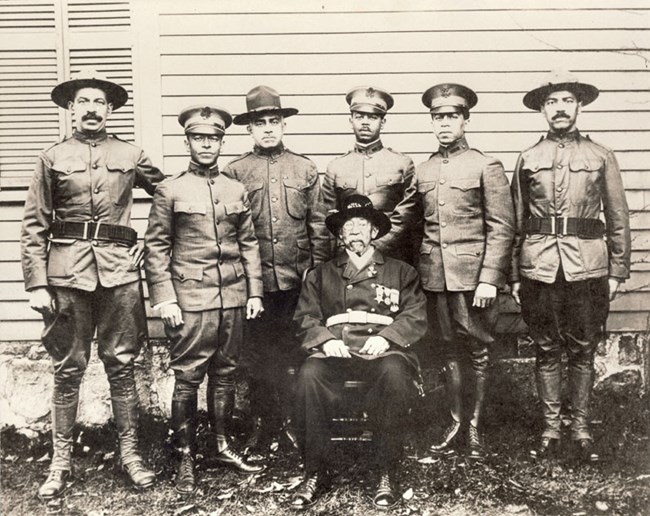 Black and white photograph of a seated William B. Gould with his six sons standing behind him. All are wearing military uniforms.