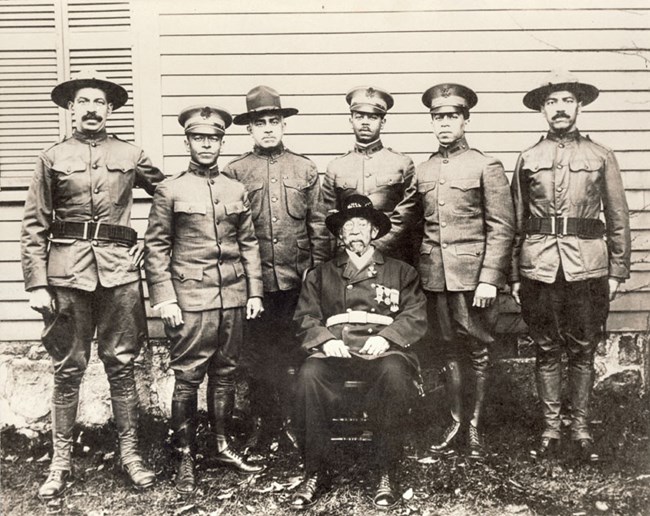 William Gould with Sons Black and white photograph of a seated William B. Gould with his six sons standing behind him. All are wearing military uniforms.