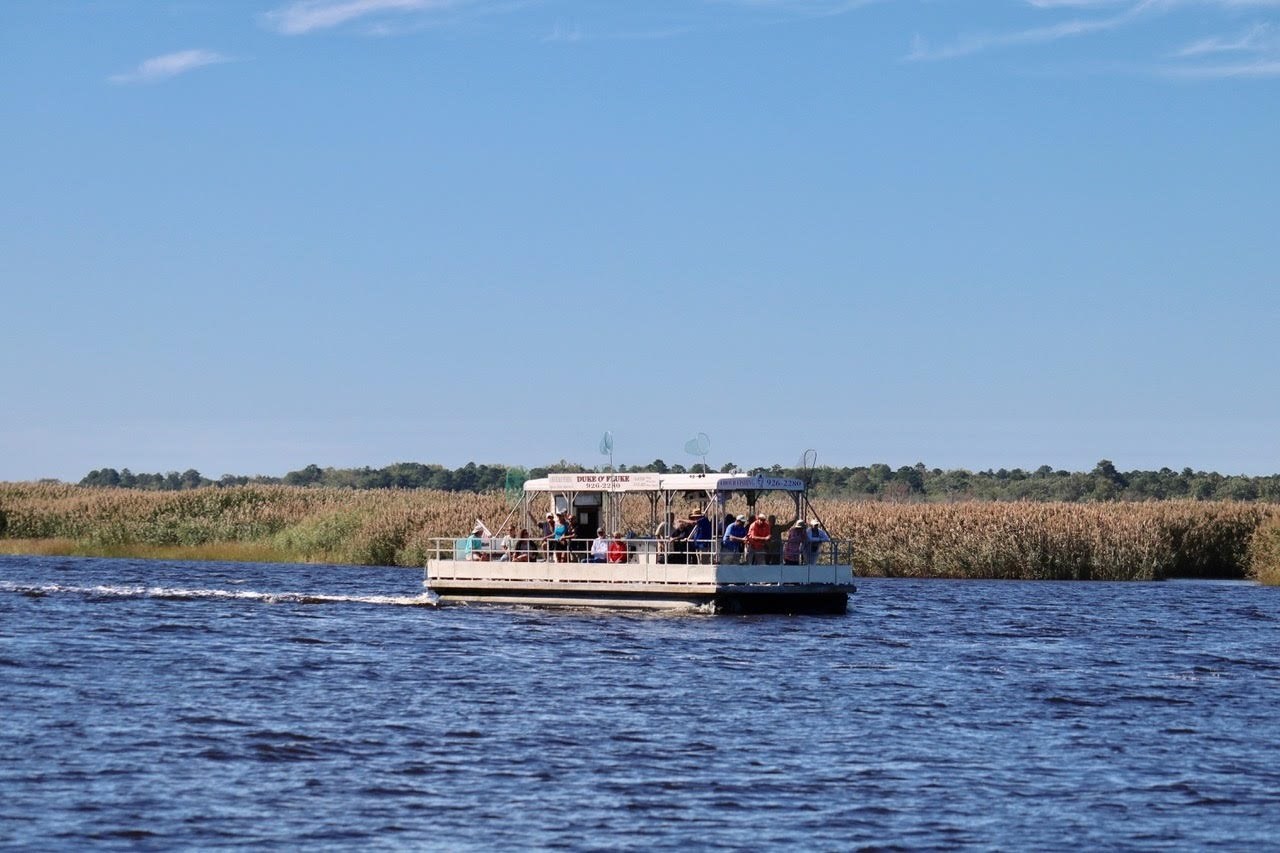 Pontoon with guests is floating on the river.