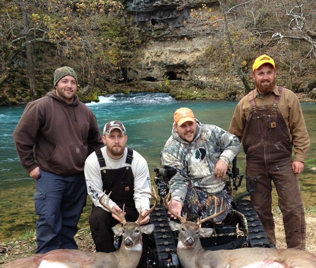 Two hunters and assistants display their deer at Big Spring.