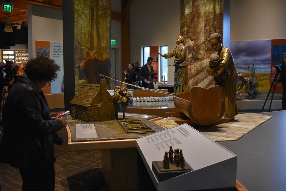 Woman reading interpretive panels in a museum