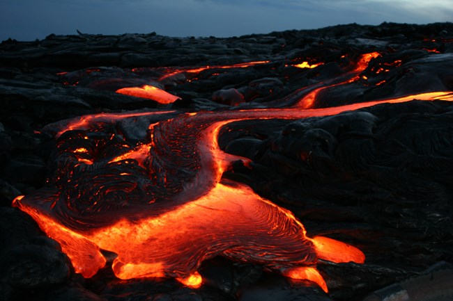 Molten lava flow at night