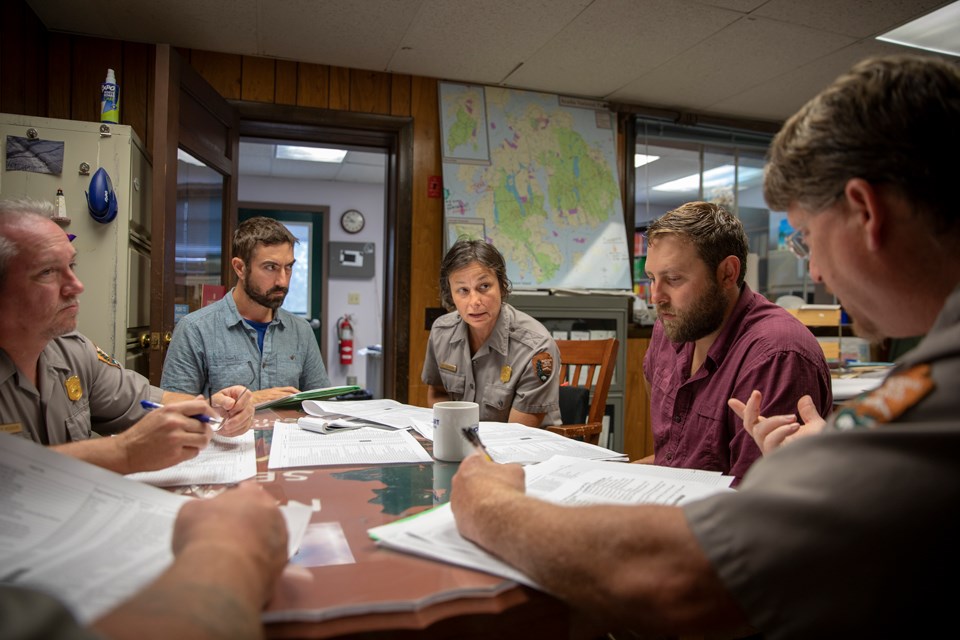 Park staff gather for discussion around a conference table
