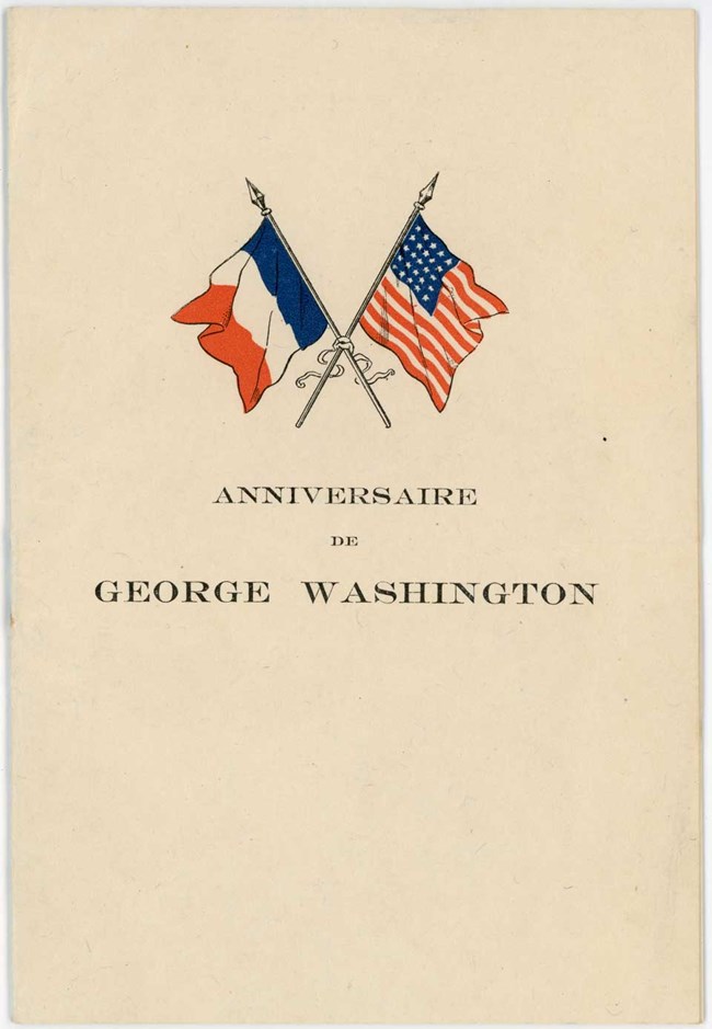 Anniversaire de George Washington Cover of pamphlet with title and crossed French and American flags