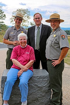 Four park and Gettysburg Foundation employees pose for a picture along Cemetery Ridge.