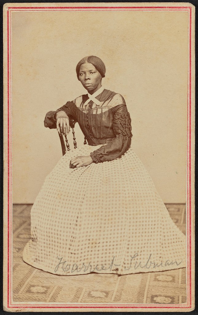 Young African-American woman in white dress and bonet