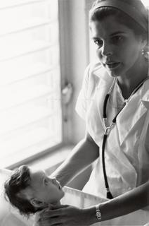 Female doctor treating an infant patient.