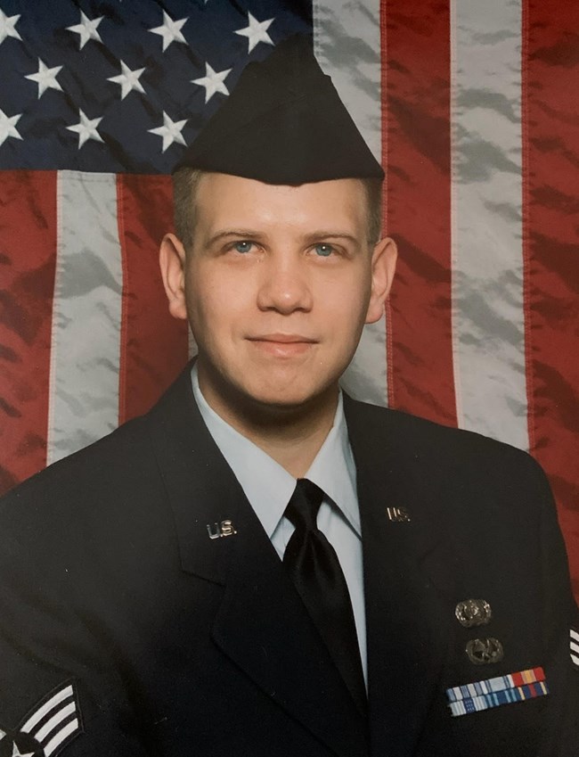 Hal T. Hoversten Man in Air Force uniform in front of an American flag