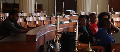 Students gather at the Old State Capitol State Historic Site during filming for the ILF Students sitting in an historic building