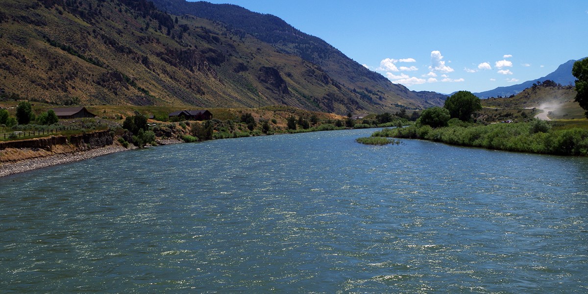 Wide flowing river flanked by tall hills