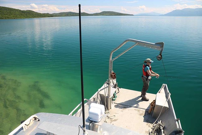 IMG_0953_web A researcher fishes in a lake from a boat.