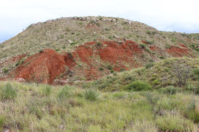 red layer exposed in hill slope
