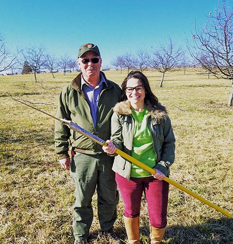 One park employee and one Gettysburg Foundation employee pose for a picture while pruning trees.