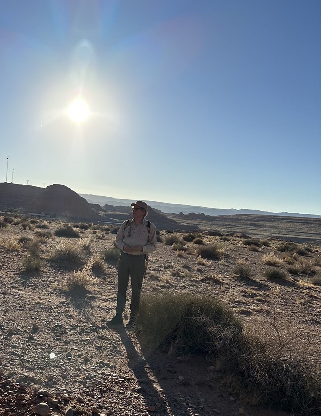 Nick Nyquist Ranger stands in desert landcape.