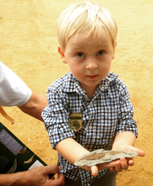 child holding a fossil