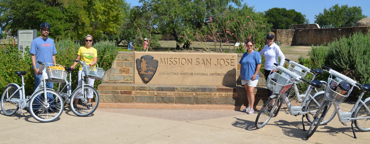 From left to right: William Flowers (National Park Foundation), Krista Sherwood (National Park Service), Julia Murphy, (City of San Antonio) and JD Simpson (San Antonio Bike Share) pose with B-Cycles at Mission San Jose.