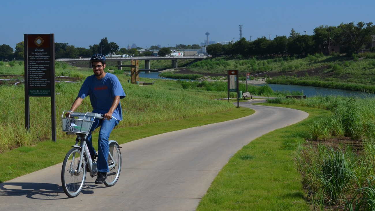 William Flowers, a Transportation Scholar with the National Park Foundation rides a Bicycle down the Mission Reach in San Antonio. William Flowers, a Transportation Scholar with the National Park Foundation rides a Bicycle down the Mission Reach in San Antonio.