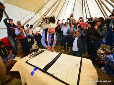 Members of the eight reservations take turns signing the Buffalo Treaty