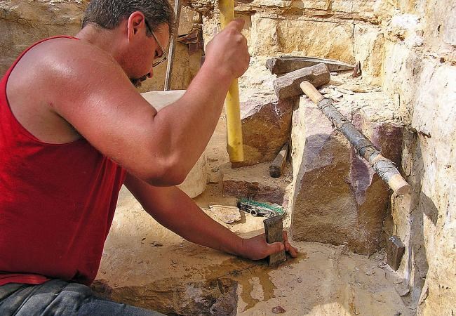 Quarrier hammering a chisel