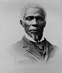Black and white photograph of an elderly African American man with white hair and wearing a suit.