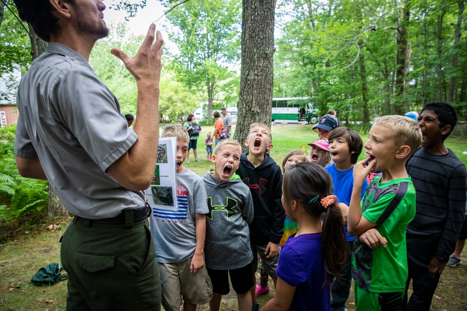 Park ranger with a group of children Park ranger with a group of children