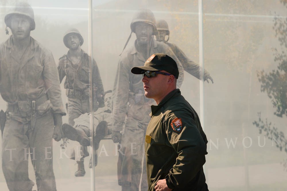 NPS staff in front of photos of soldiers
