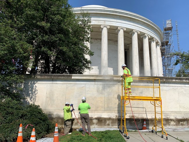 Architectural conservators apply steam to the terrace wall of the Jefferson Memorial as part of the GAOA-funded cleaning of the memorial.