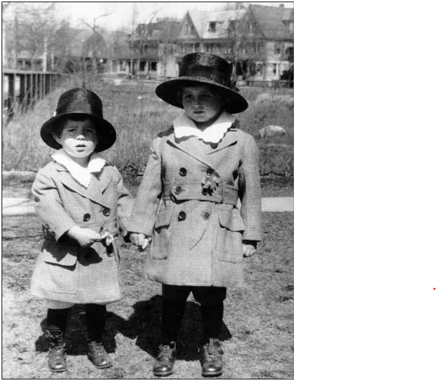 lt= Two young boys standing outside in matching clothing