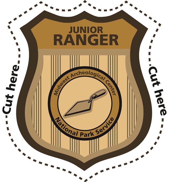 Gold badge that says "JUNIOR RANGER" at the top with an illustration of a trowel in the center surrounded by the words "Midwest Archeological Center" and "National Park Service"