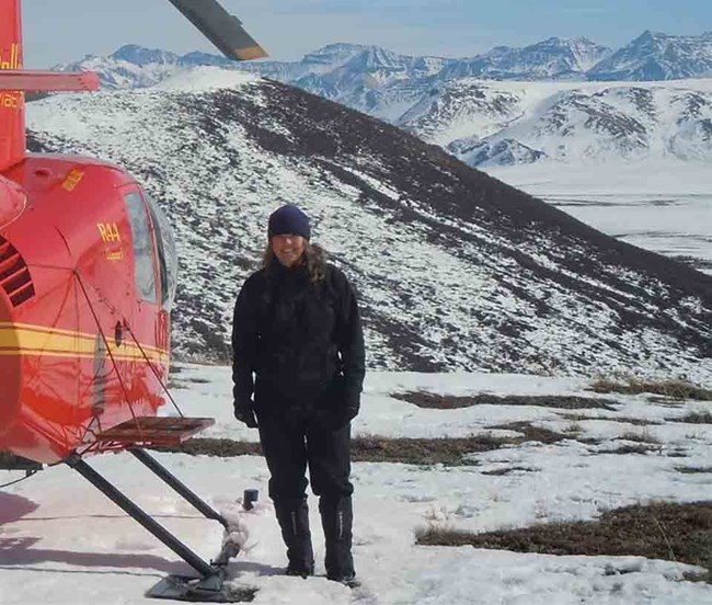 Judy Putera WRST caribou study Wildlife Biologist Judy Putera stands by a helicopter in the winter.