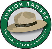 Illustration of a ranger hat in the center of a circle with the junior ranger motto of "explore, learn, protect" in white text.