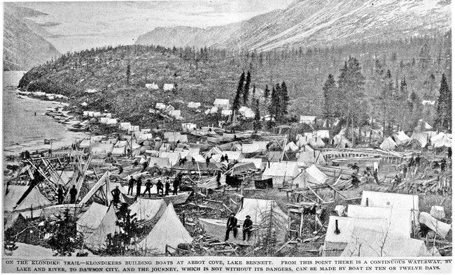 Tents and buildings along a lake