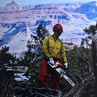 Kacey Dodds Firefighter Dodds using a chainsaw to chop wood