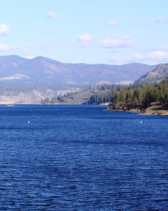 view across water to low hills