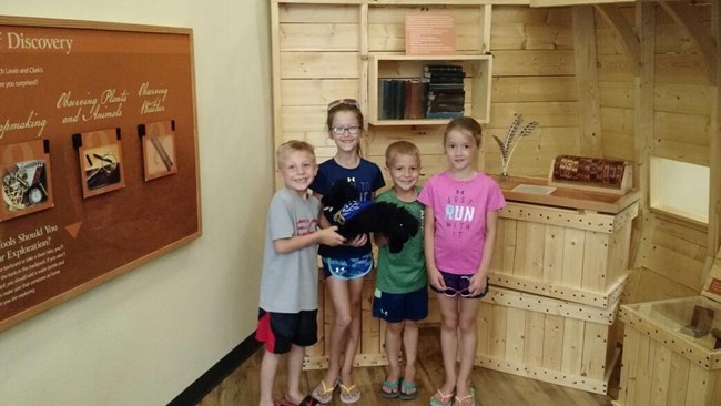 LC1 Four kids holding a toy dog