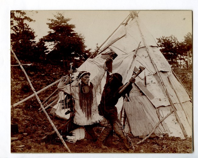 Theatrical performance of two Native Americans sparring