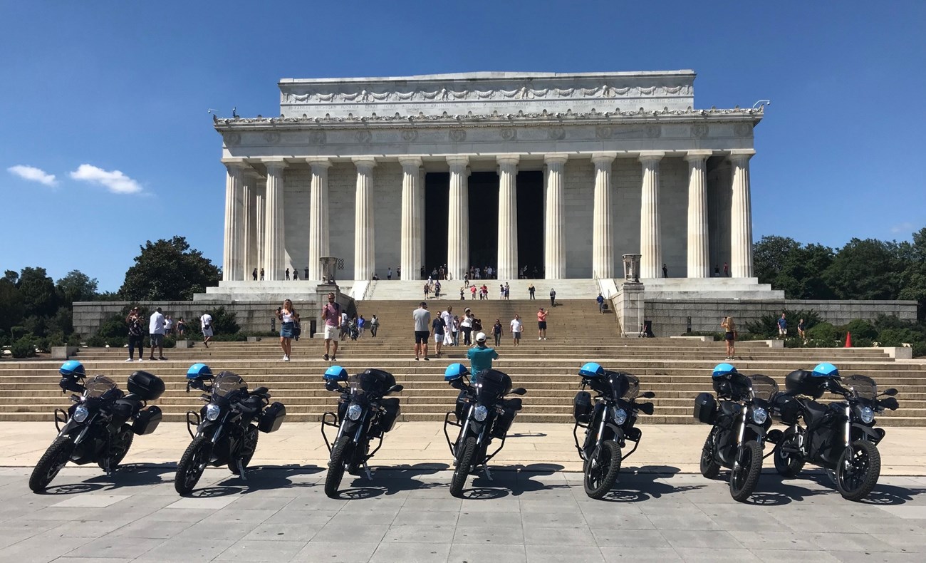 LINC Ebikes (USPP) Line of electronic motobikes in front of the Lincoln Memorial