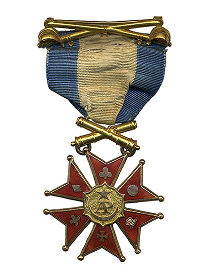 Medal with six red enamel points hanging on blue and white ribbon with bars of crossed sabers and crossed cannon