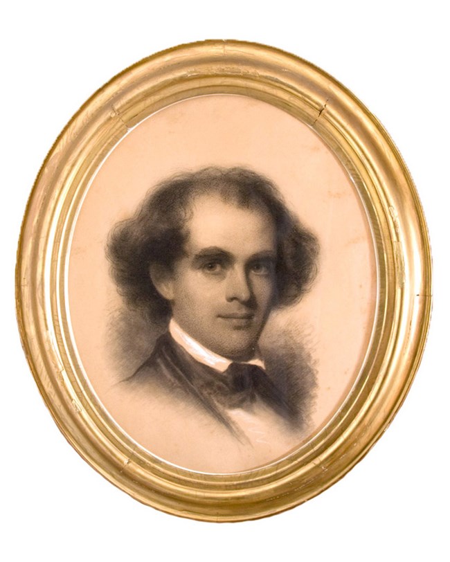 Bust-length portrait of man in charcoal with chalk highlights in gold oval frame