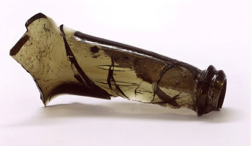lt= broken neck of a green glass wine bottle