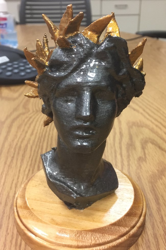 Small bust of a woman's face made on a 3D printer.